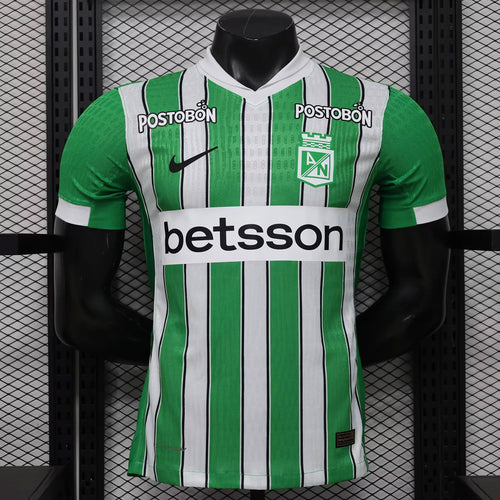 Green and white striped soccer jersey with POSTOBON and betsson sponsor prints