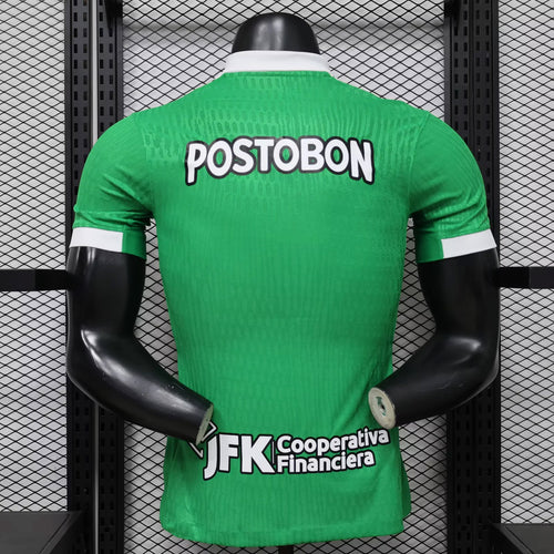 Back view green soccer jersey with POSTOBON lettering and white sponsor text