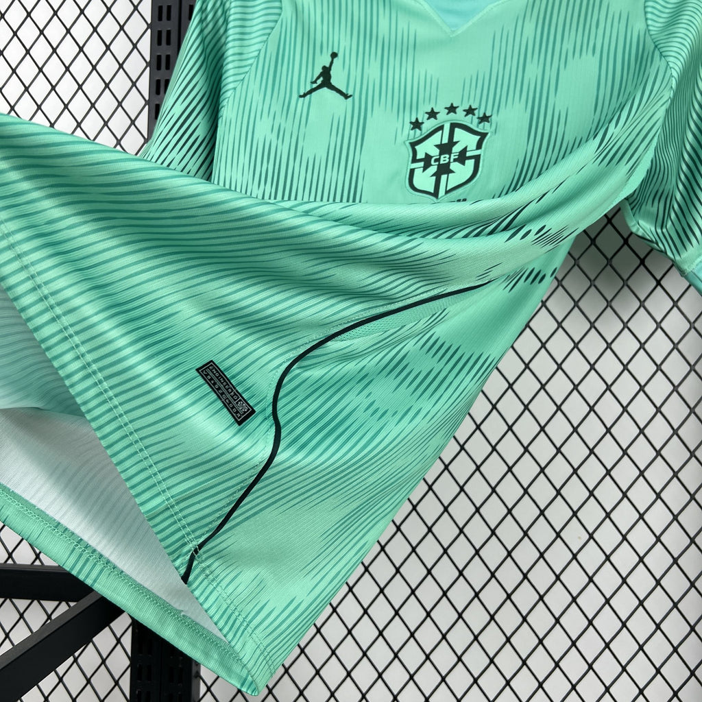 Turquoise goalkeeper jersey sleeve close-up with black piping and crest badge