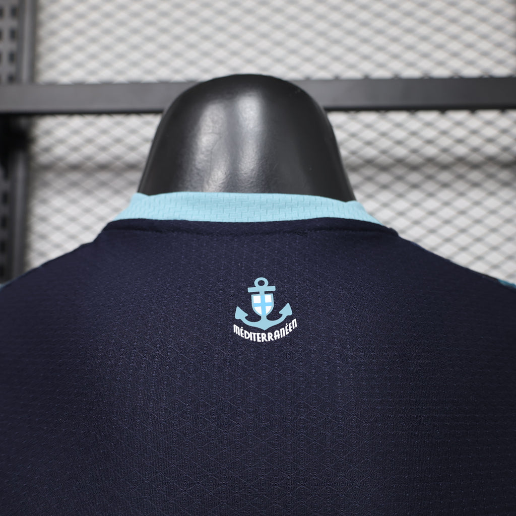 Navy jersey back with light-blue collar trim and Mediterranean anchor crest