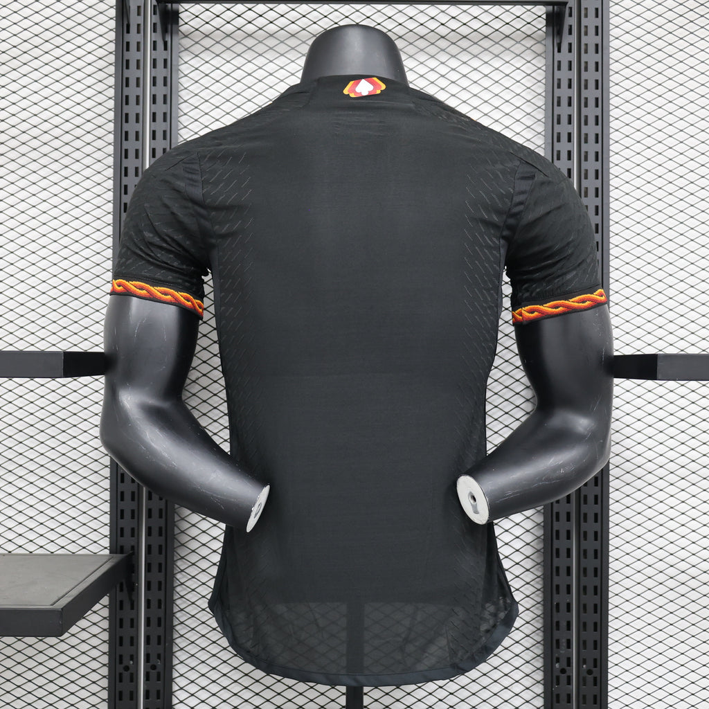 Roma third football jersey, black with rear button placket and red-orange sleeve trim