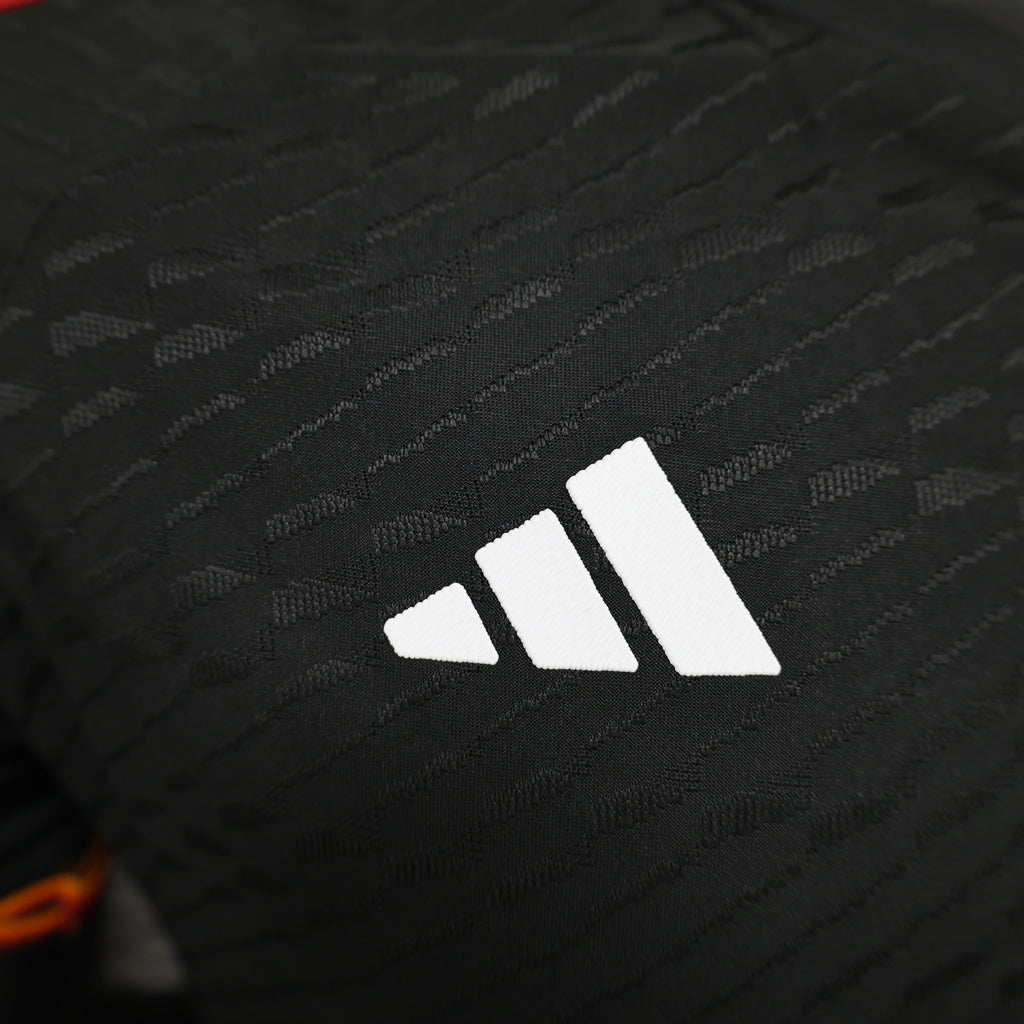 Roma third football jersey, close-up of white Adidas logo on black fabric