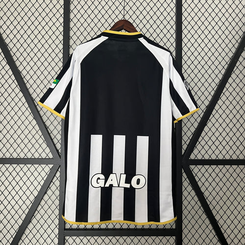 Retro black-and-white striped soccer jersey back view with yellow trim and GA LO text