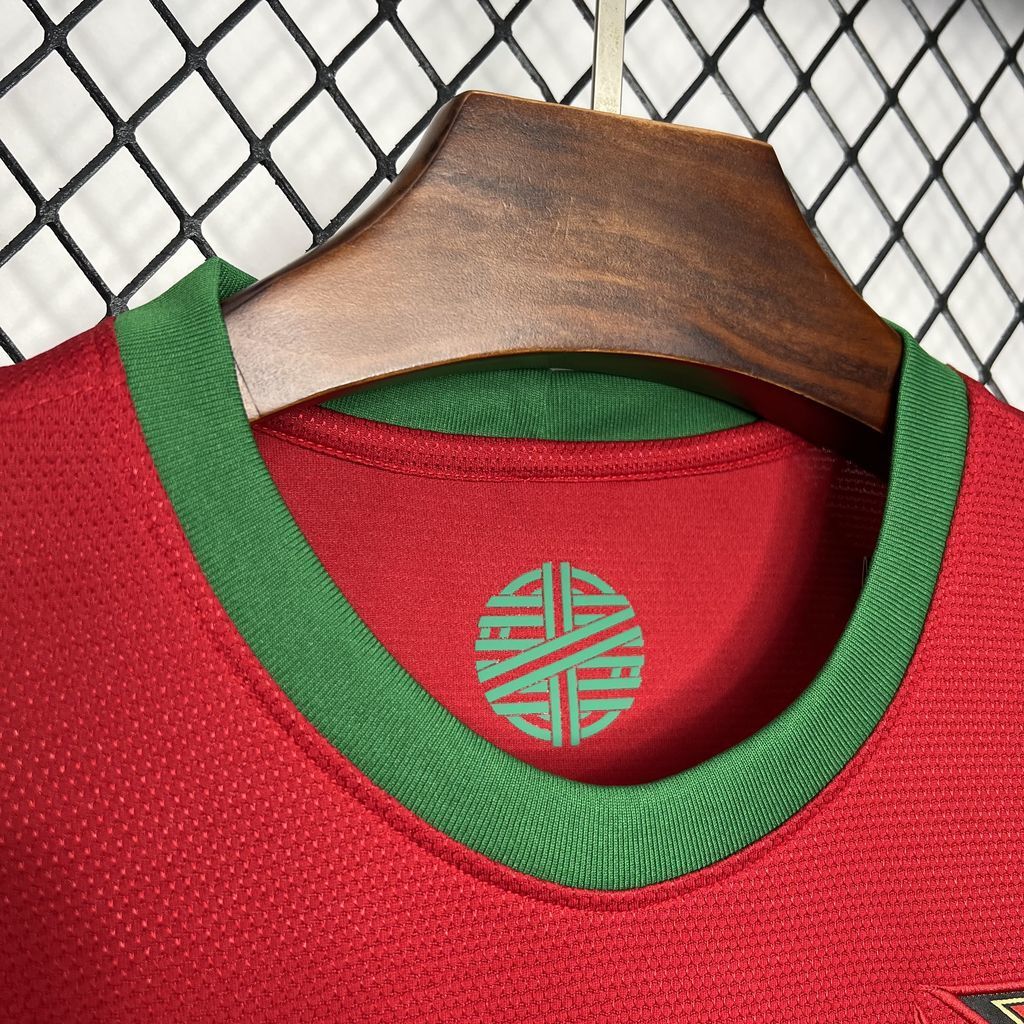 Red soccer jersey neckline with green trim and Portugal crest detail.