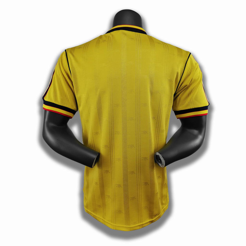 Yellow retro football jersey on a mannequin, back view with navy collar and sleeve trim