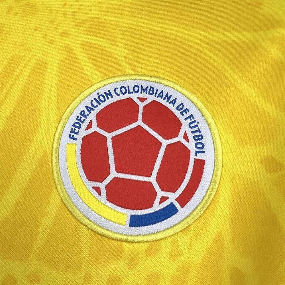 Colombia football federation badge on yellow soccer jersey chest.