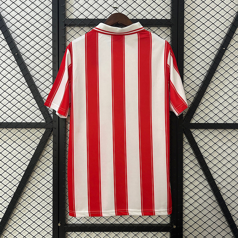 Red-and-white vertical striped soccer jersey with short sleeves and rounded ribbed collar