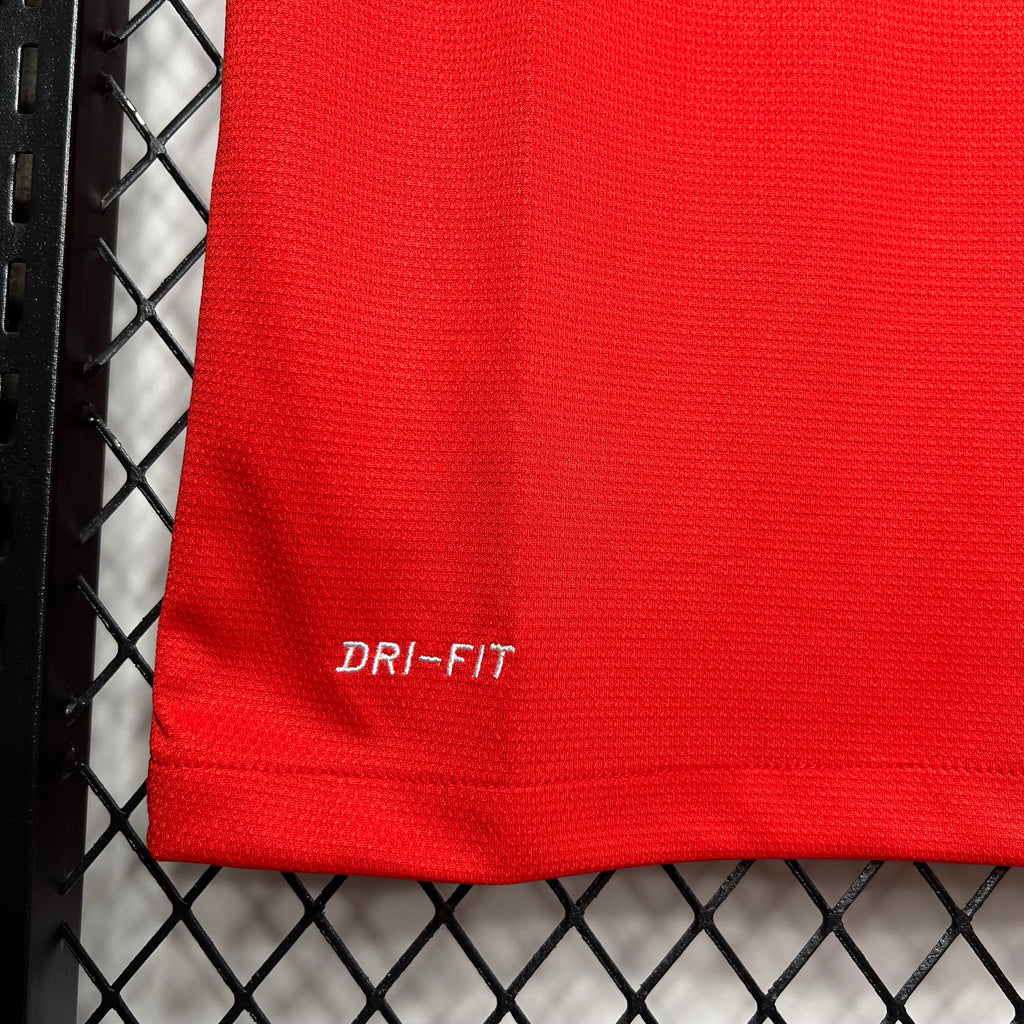 Red jersey fabric close-up showing Dri-FIT text
