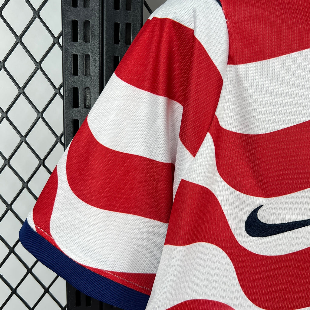 USA soccer jersey sleeve in red and white stripes with blue trim and Nike swoosh