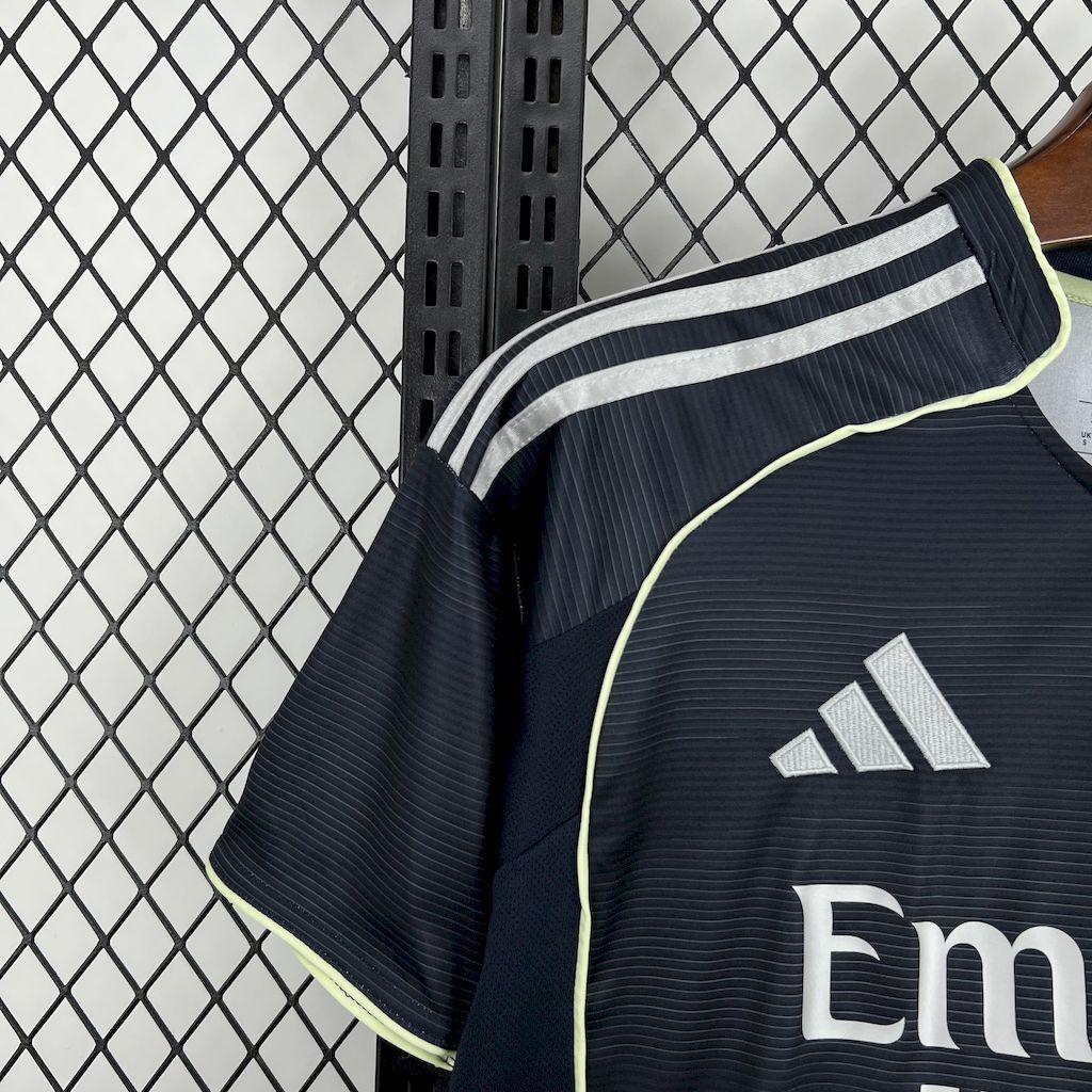 Dark navy Real Madrid away fan jersey shoulder with white Adidas stripes and lime piping