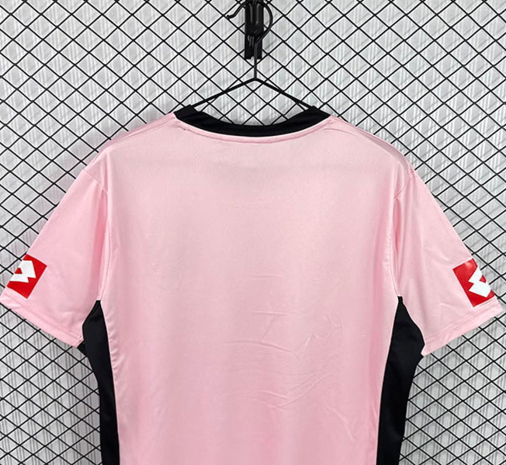 Pink football jersey back view with black side panels and short sleeves