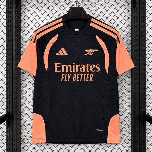 Black football training top with orange side panels and Emirates logo on chest