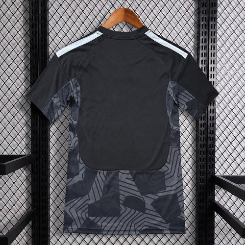 Black goalkeeper fan jersey back with white shoulder stripes and dark geometric graphic