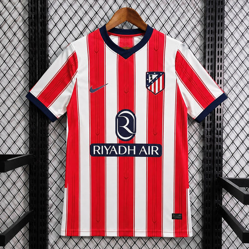 Red and white striped football jersey with navy V-neck and RIYADH AIR sponsor print
