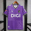 Purple football jersey, V-neck with crest and 'DIGI' sponsor, short sleeves.