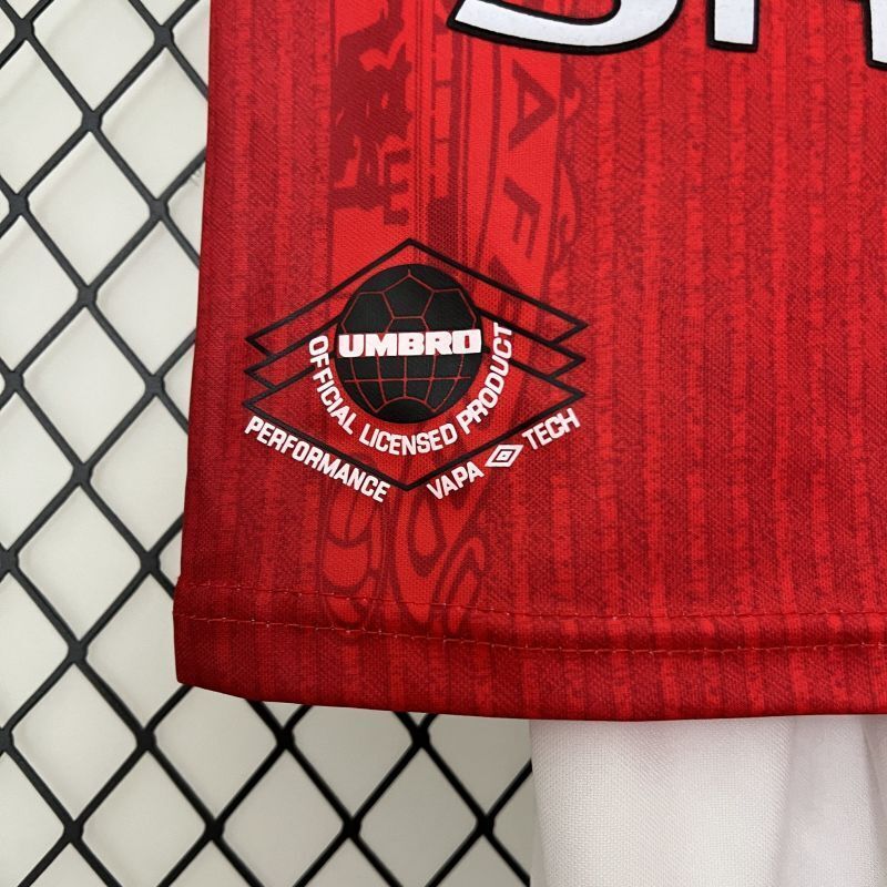 UMBRO performance label on red jersey hem