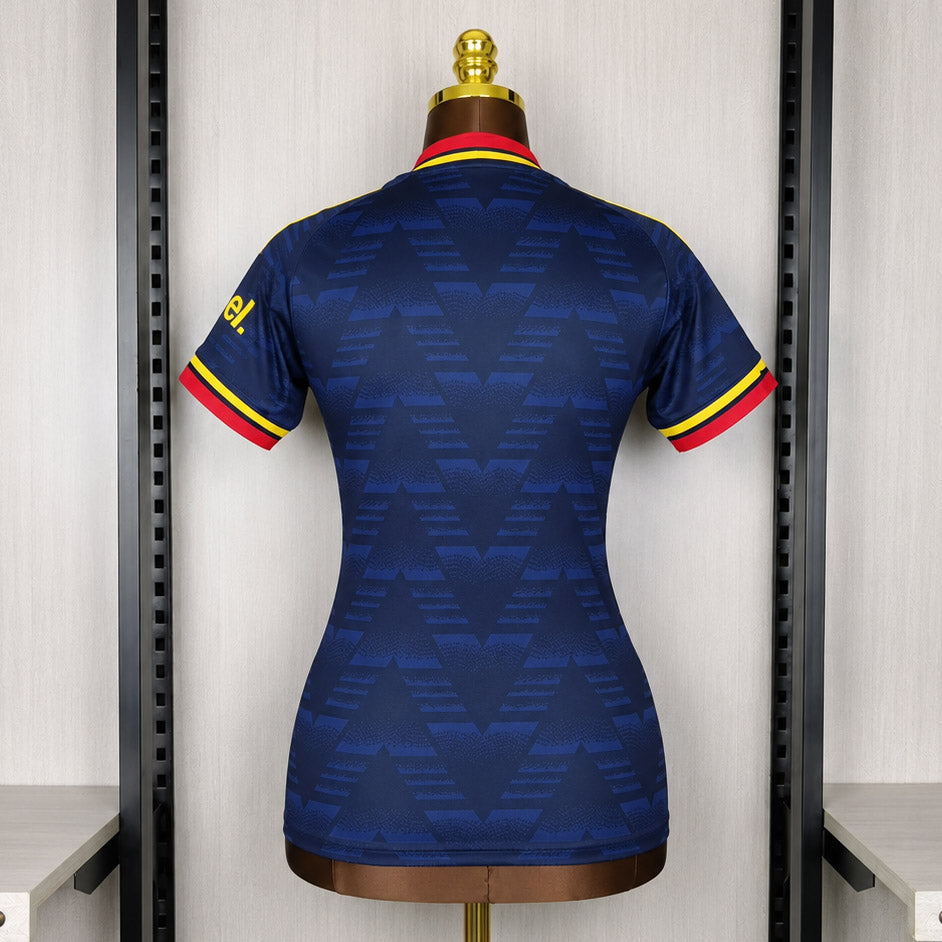 Women’s dark blue Arsenal away soccer jersey, back view with yellow shoulder stripes and red trim