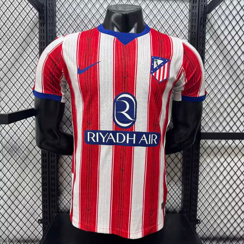 Atletico Madrid home football jersey, red-and-white vertical stripes, blue trim, RIYADH AIR sponsor.