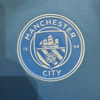Manchester City club crest embroidered on light blue football jersey