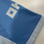 Light blue jersey sleeve with white trim and large number-style logo detail