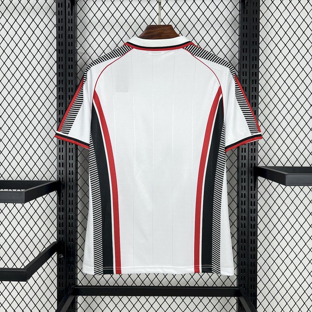 White retro soccer jersey with red and black side stripes, short sleeves, crew neckline