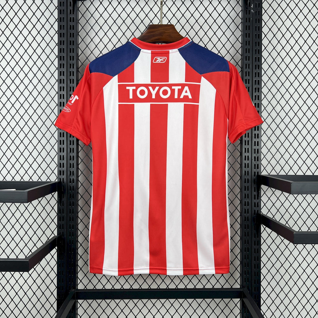 Retro soccer jersey back with red-and-white vertical stripes, blue shoulders, Toyota