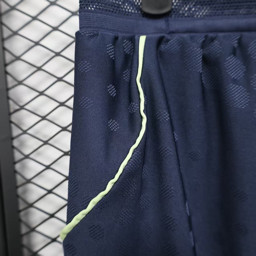 Navy player shorts side view with lime piping and white stripe panel