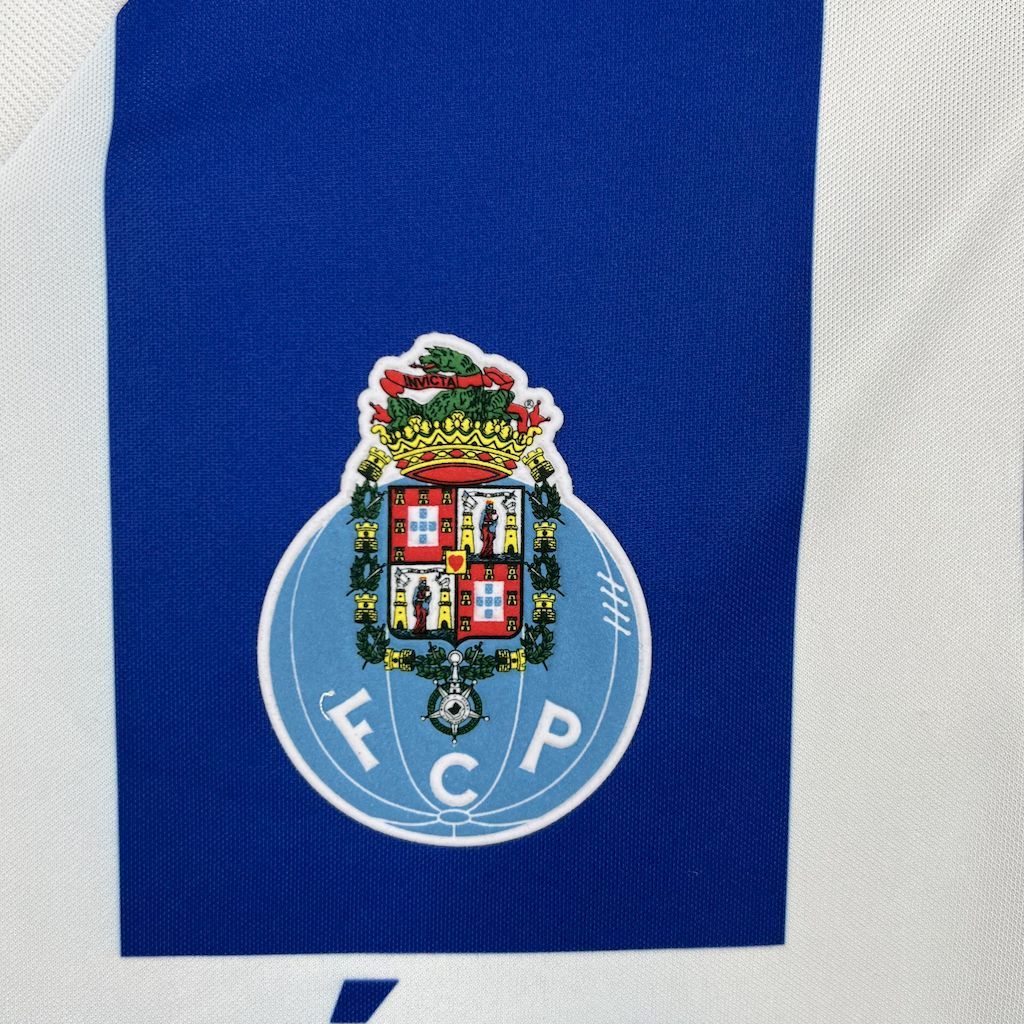 Close-up crest patch on blue panel of a blue and white striped retro home jersey