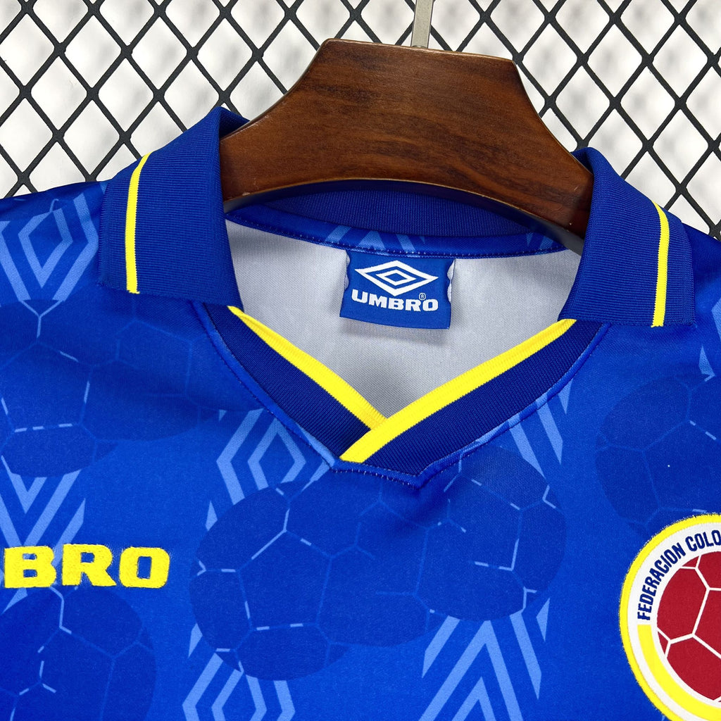 Blue Umbro long-sleeve jersey with yellow-trim V collar, patterned fabric and crest
