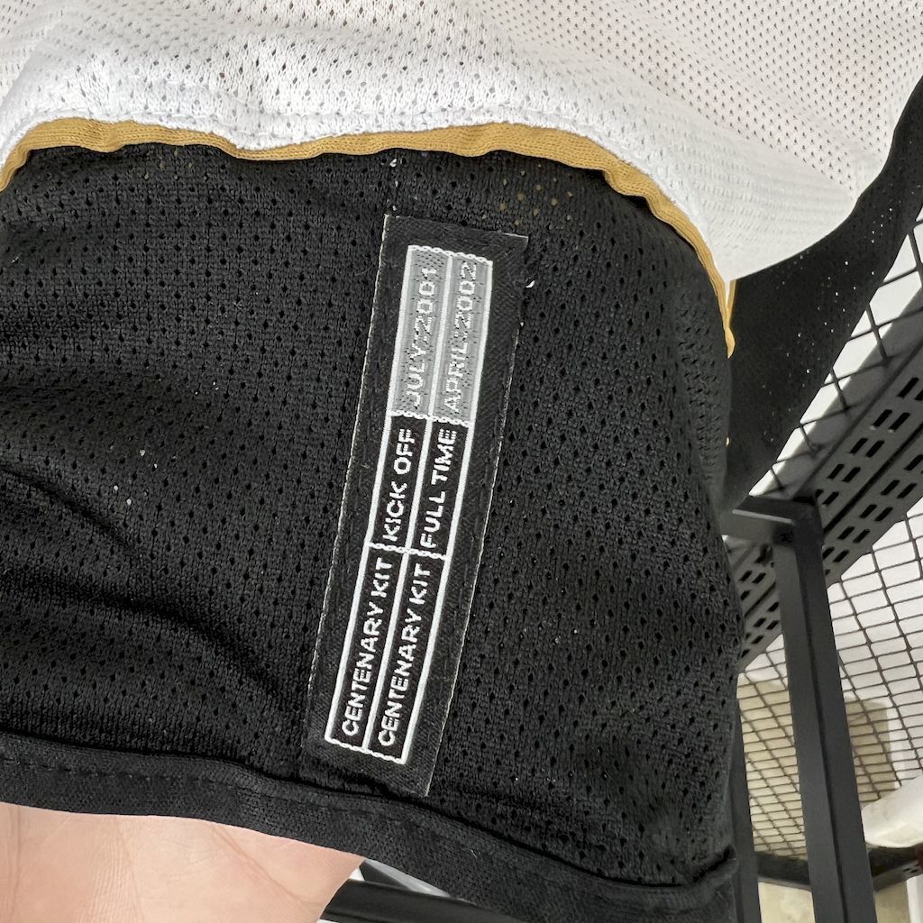 Black mesh jersey inner neck label with Centenary Year 1902–2002 text