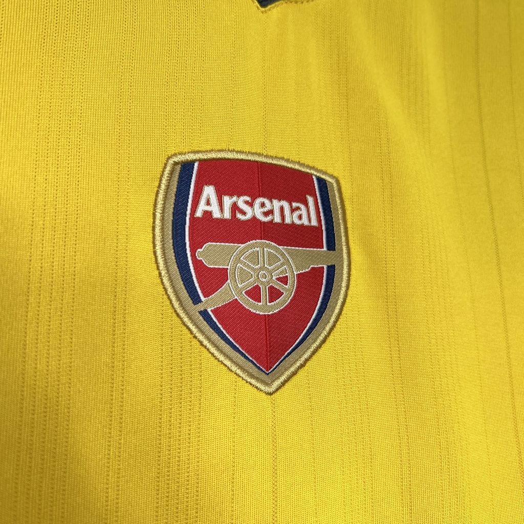 Arsenal crest patch on yellow football jersey chest