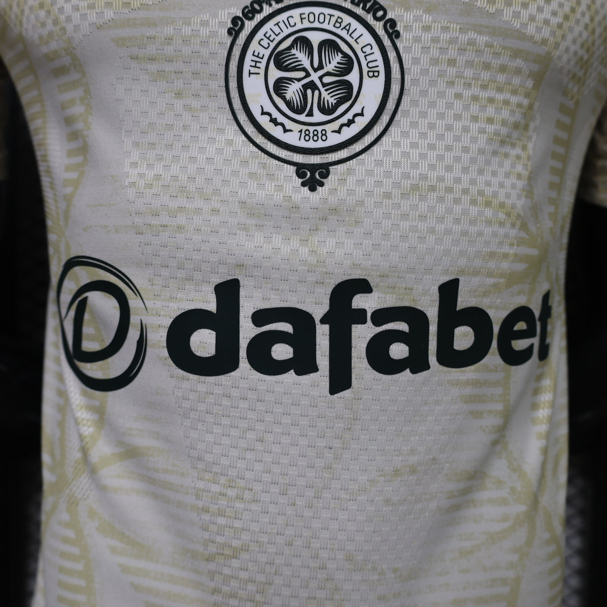 Light yellow jersey with Celtic FC round crest and black dafaBet sponsor