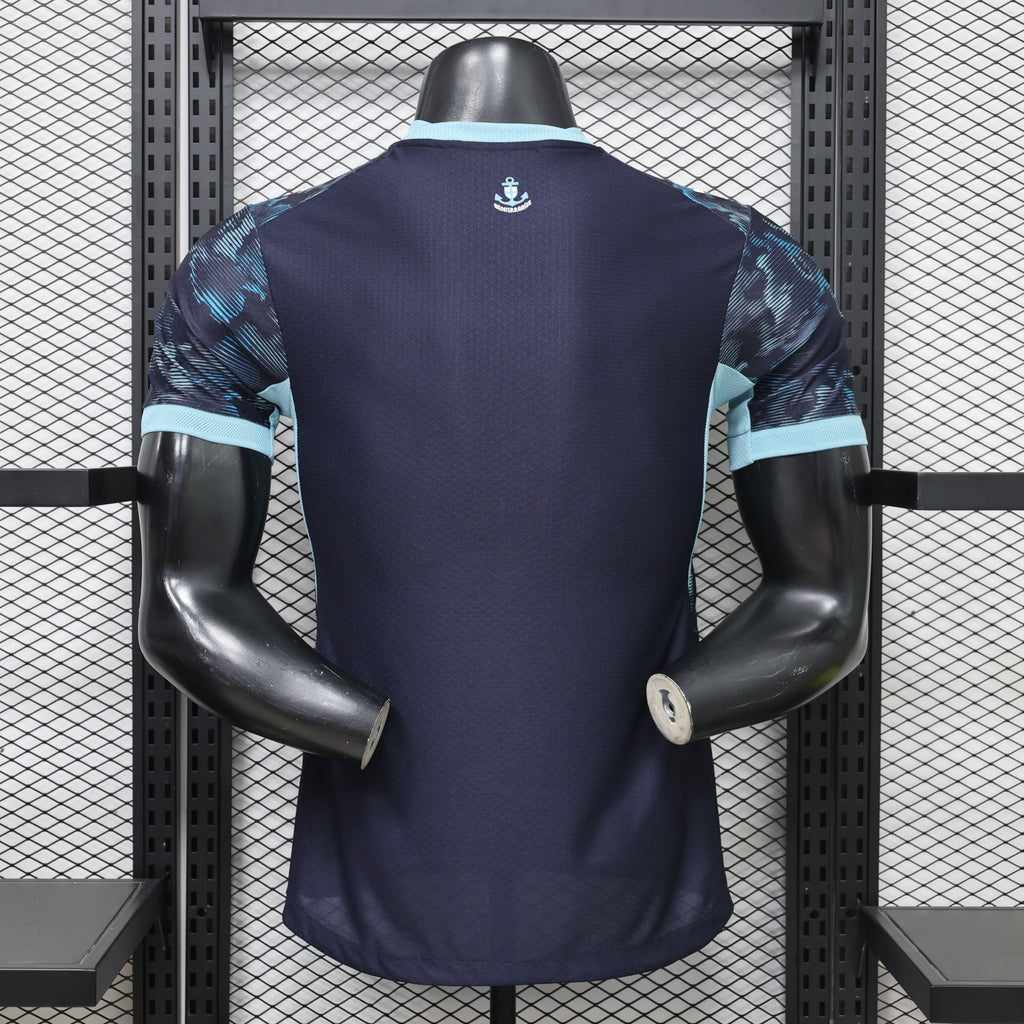 Navy away football jersey back view with light-blue sleeve trim and anchor badge
