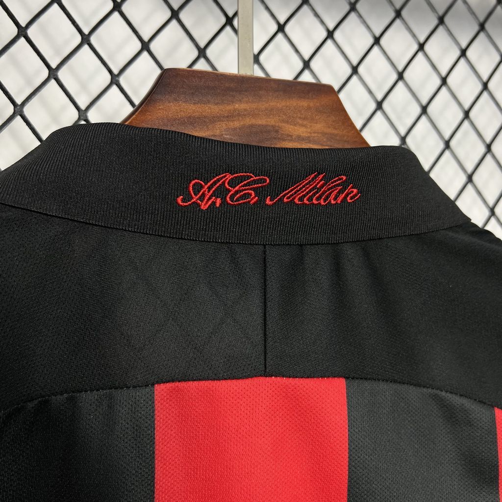 Black jersey collar detail with red embroidered script on back neck