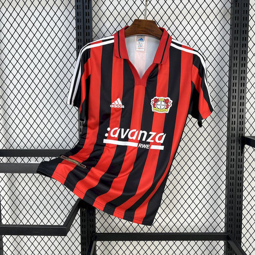 Men's football jersey with red and black vertical stripes, adidas logo, crest, and sponsor print