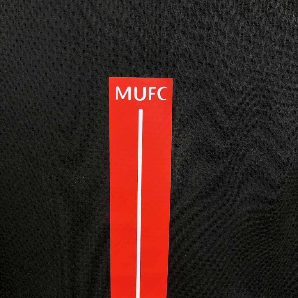 Retro away football jersey MUFC red vertical sponsor patch on black fabric