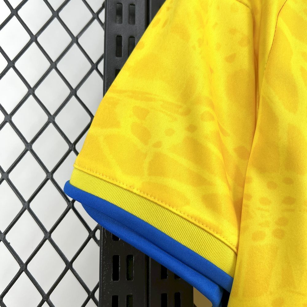 Yellow soccer jersey sleeve with blue cuff and elastic hem trim, short-sleeve style.