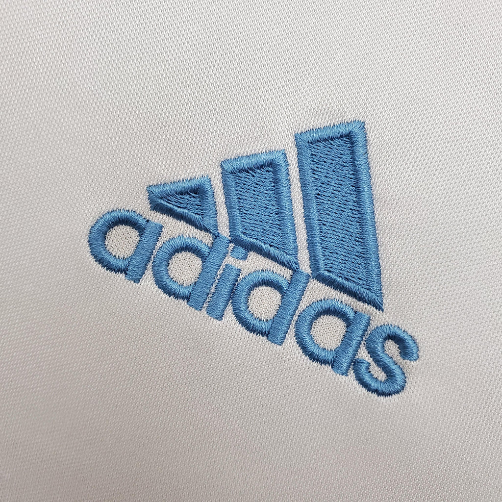 Light blue adidas logo embroidery on white jersey fabric