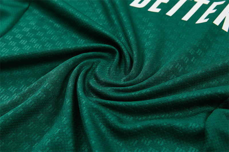 Green training fabric close-up with subtle texture and folded seam
