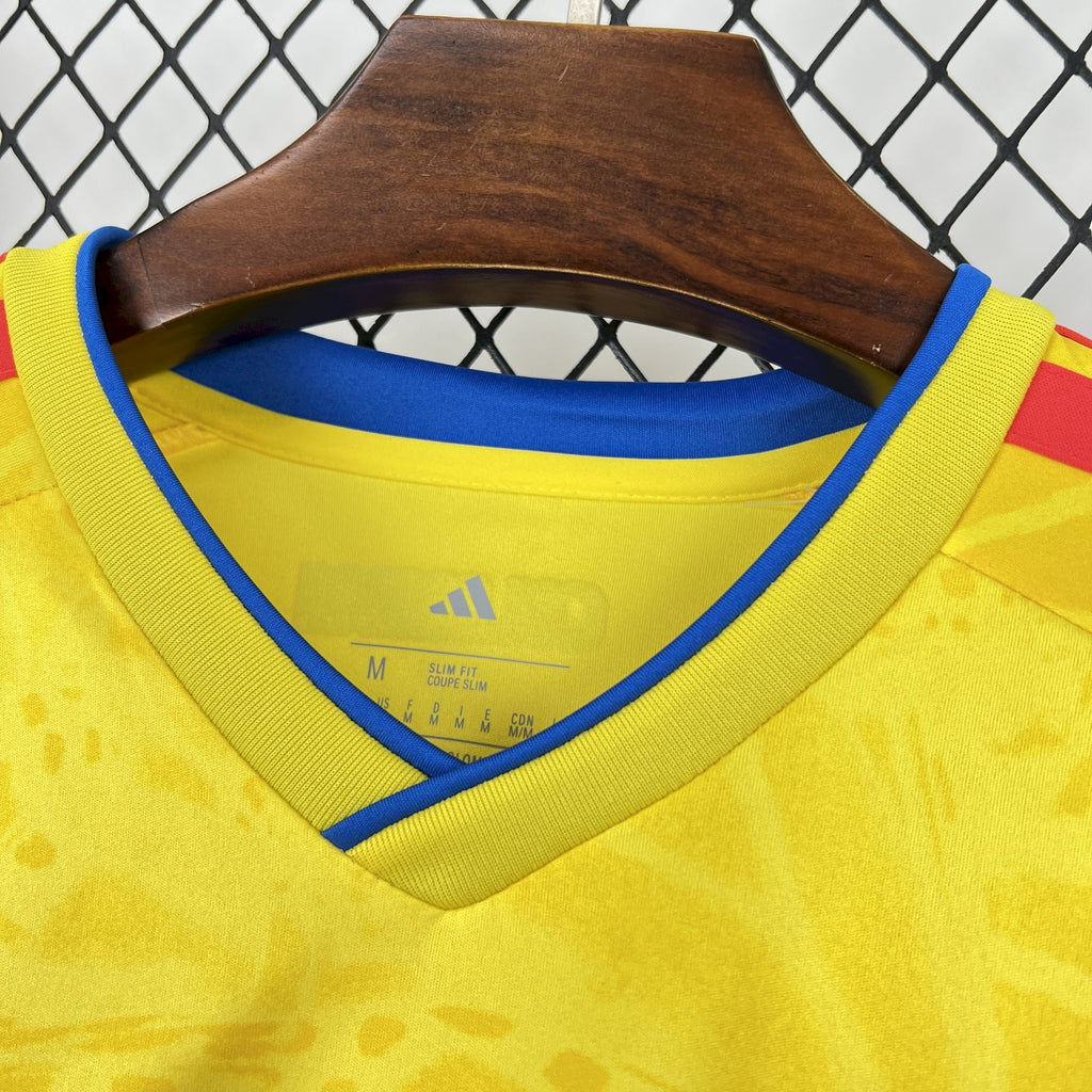 Yellow long-sleeve soccer jersey with blue V-neck trim and small size label at collar.