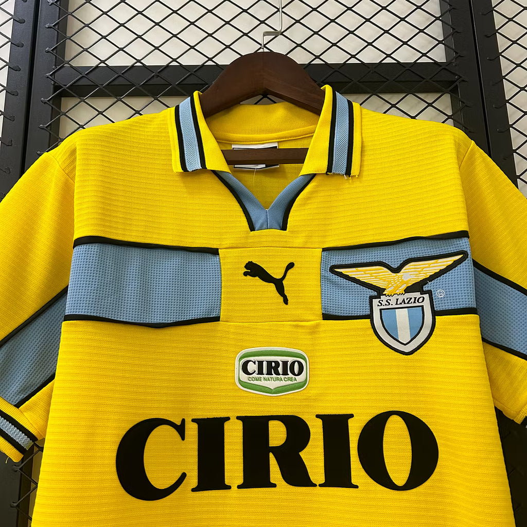 Yellow retro soccer jersey with light blue panels, PUMA logo, Lazio crest, CIRIO