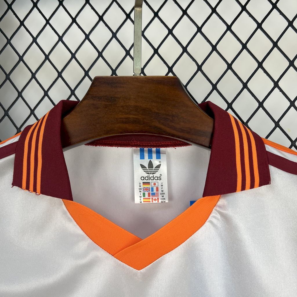 White soccer jersey neckline with orange V-neck, striped collar, adidas size label