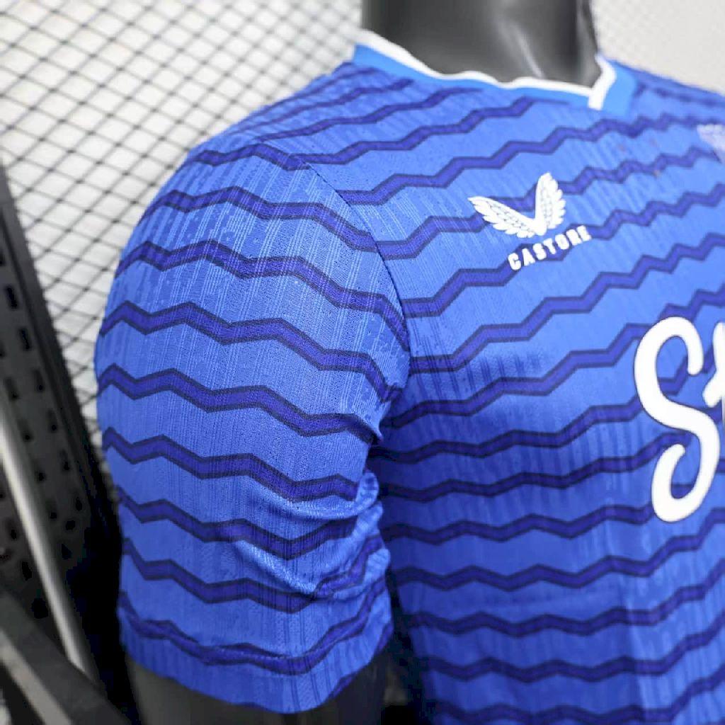 Blue long-sleeve football jersey with zigzag pattern and large white number detail