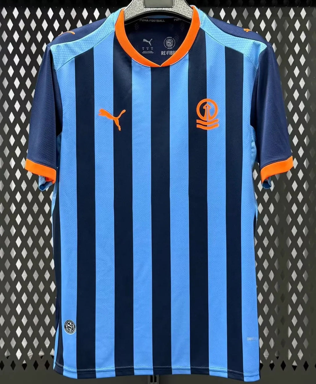 Blue vertical striped football jersey with orange trim and short sleeves