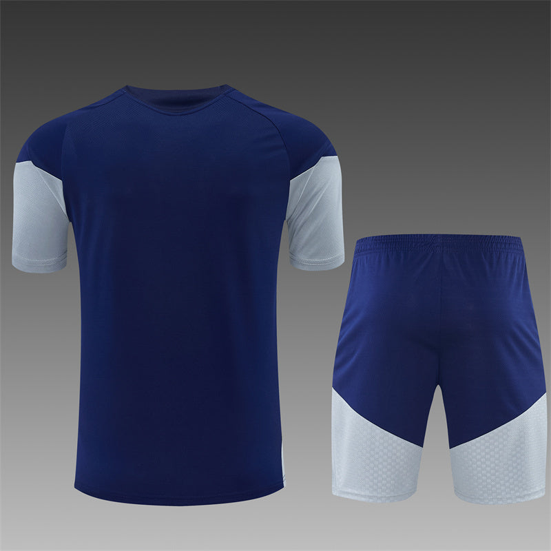 Navy training shirt and shorts set with white side panels, full back view.
