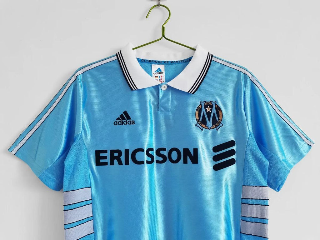 Sky blue away soccer jersey front with ERICSSON sponsor, adidas logo, and club badge