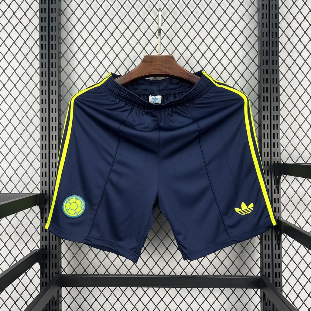 Navy football fan shorts with neon yellow side stripes and crest patch
