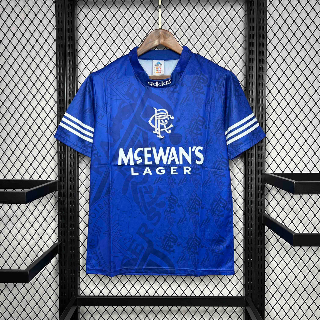 Blue home retro football shirt with Adidas logo, white sleeve stripes, McEwan's Lager print