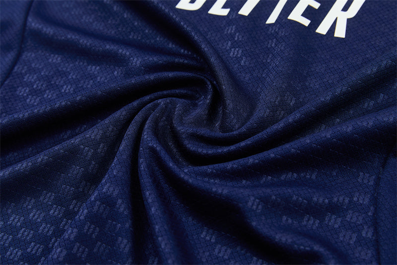 Navy training jersey fabric close-up with textured pattern and folds.