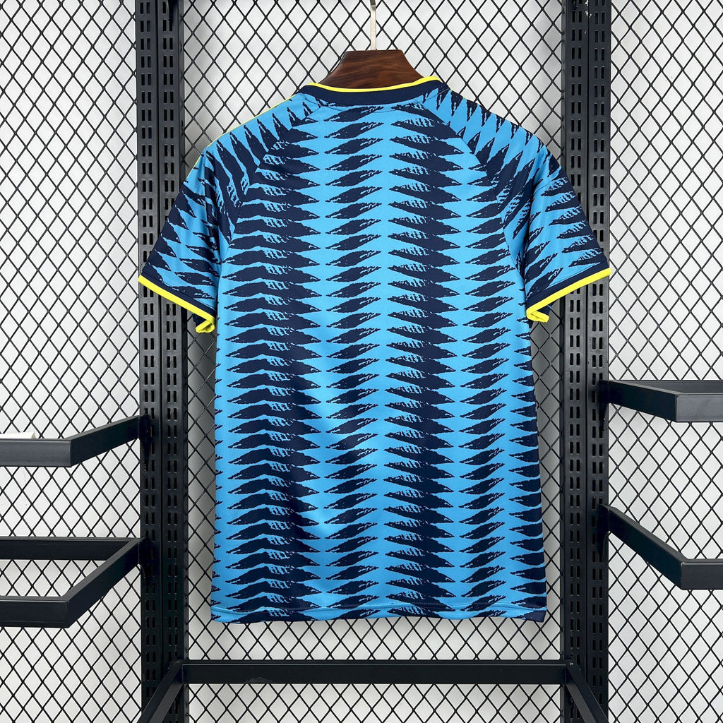Back view of blue football jersey with yellow-trimmed collar and zigzag wave pattern